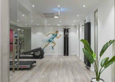 Moderner Fitnessraum mit Wandgrafik und Sportgeräten im Mercure Hotel Köln Belfortstraße